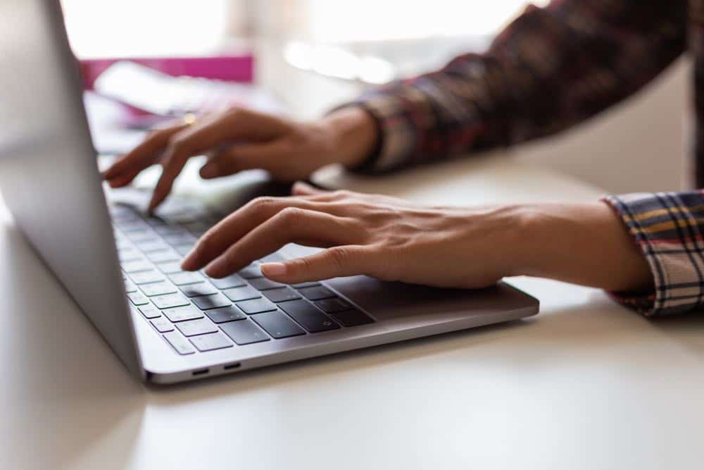 Businessman hands busy using laptop at office desk, young female student typing on computer sitting at wooden table